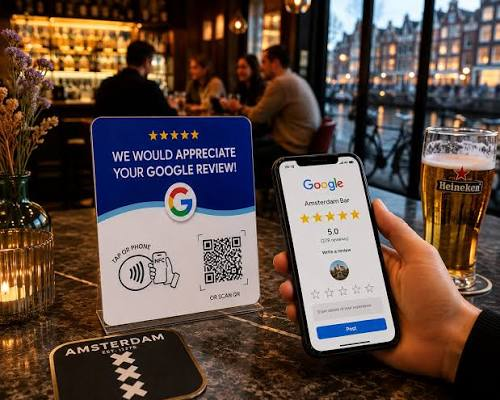 Google review stand on a bar table, with a phone open on the review page