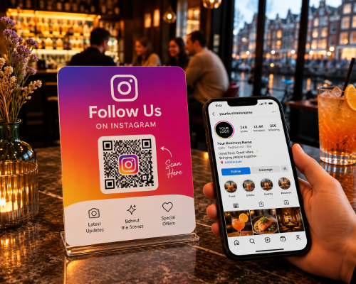 Instagram follow-us stand on a café table, with a phone open on the profile